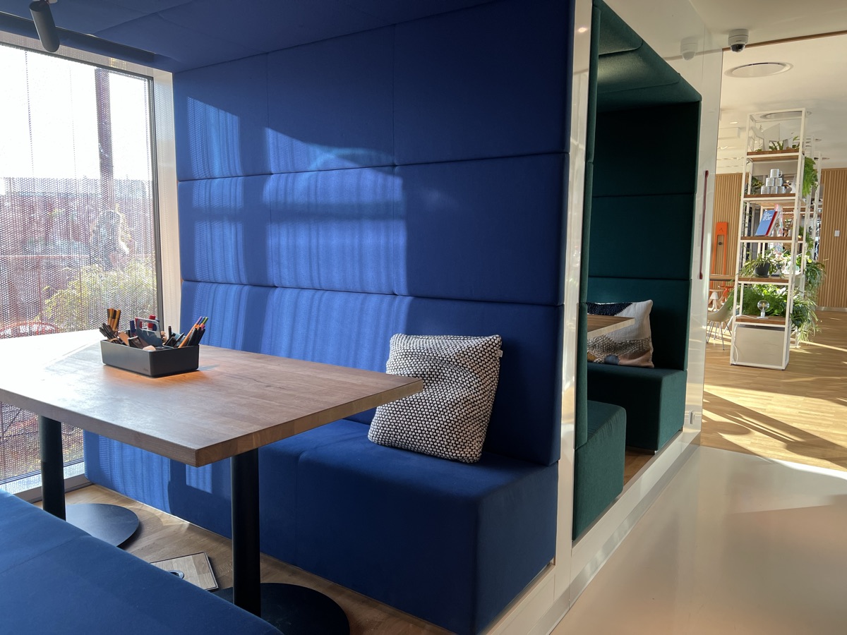 A quiet blue booth with a table at Zoku Copenhagen
