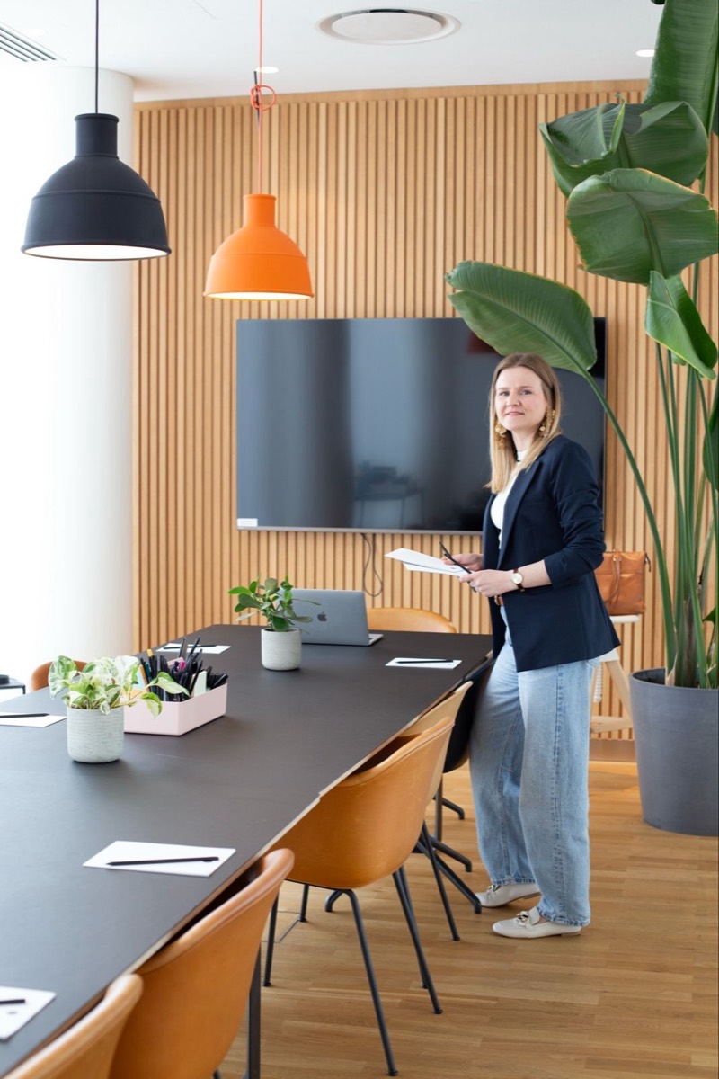 Anna in a meeting room set up for a session